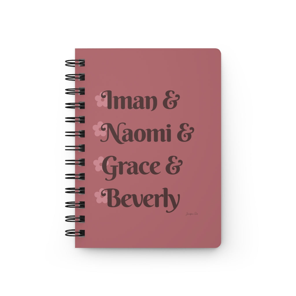 A pink notebook with dark pink text that reads "Iman & Naomi & Grace & Beverly" in reference to the Black models Iman Abdulmajid, Naomi Campbell, Grace Jones, and Beverly Johnson