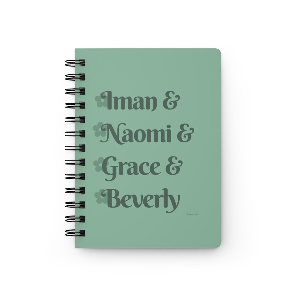 A light green notebook with dark green text that reads "Iman & Naomi & Grace & Beverly" in reference to the Black models Iman Abdulmajid, Naomi Campbell, Grace Jones, and Beverly Johnson