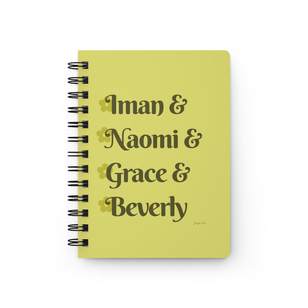 A yellow notebook with dark yellow text that reads "Iman & Naomi & Grace & Beverly" in reference to the Black models Iman Abdulmajid, Naomi Campbell, Grace Jones, and Beverly Johnson