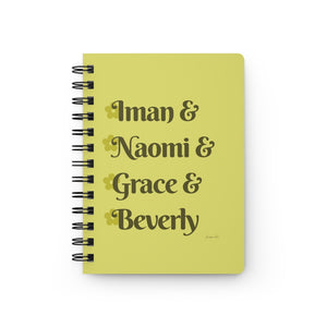 A yellow notebook with dark yellow text that reads "Iman & Naomi & Grace & Beverly" in reference to the Black models Iman Abdulmajid, Naomi Campbell, Grace Jones, and Beverly Johnson