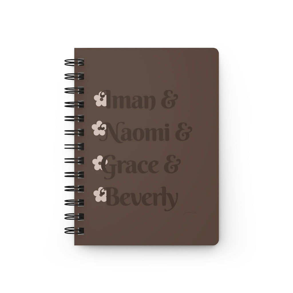 A brown notebook with dark brown text that reads "Iman & Naomi & Grace & Beverly" in reference to the Black models Iman Abdulmajid, Naomi Campbell, Grace Jones, and Beverly Johnson