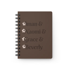 A brown notebook with dark brown text that reads "Iman & Naomi & Grace & Beverly" in reference to the Black models Iman Abdulmajid, Naomi Campbell, Grace Jones, and Beverly Johnson