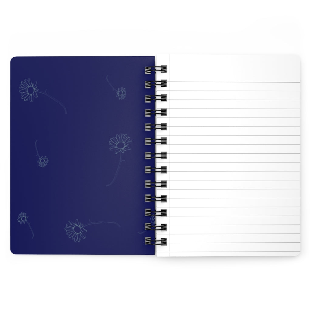 The inside cover of a lined journal that is dark blue with simple light blue flowers