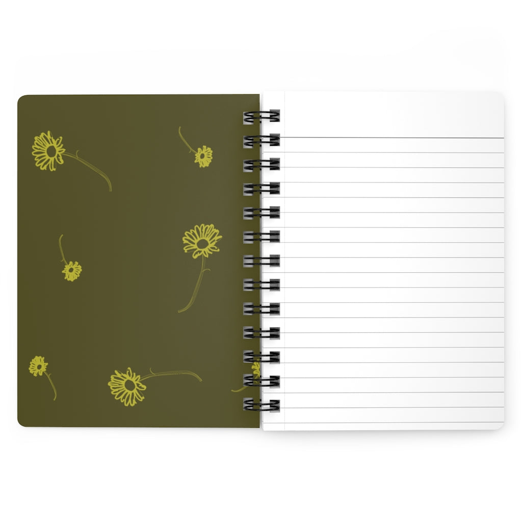 The inside cover of a lined journal that is dark yellow with simple light yellow flowers