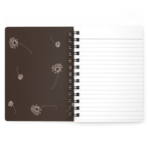 The inside cover of a lined journal that is brown with simple beige flowers