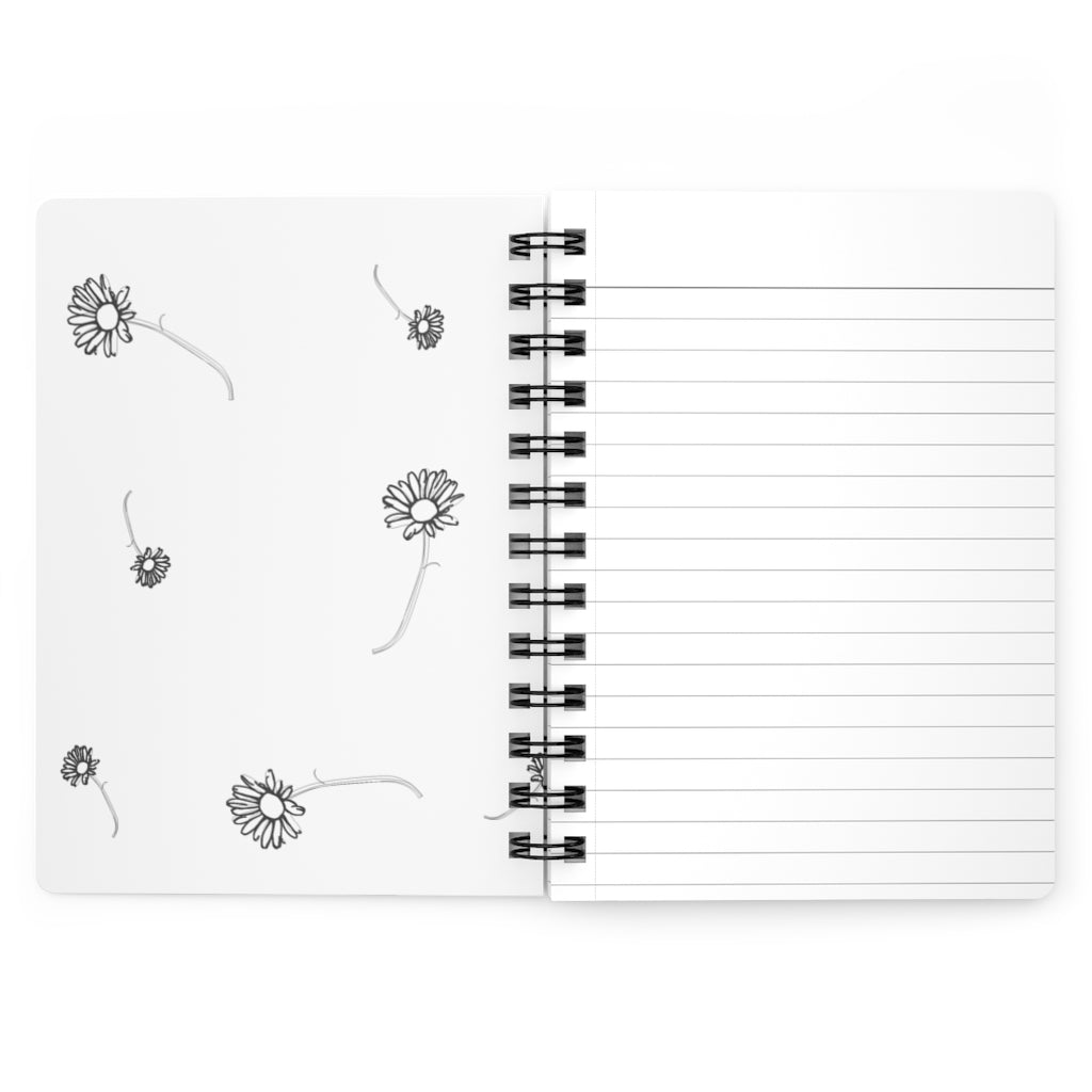 The inside cover of a lined journal that is white with simple black flowers