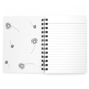 The inside cover of a lined journal that is white with simple black flowers