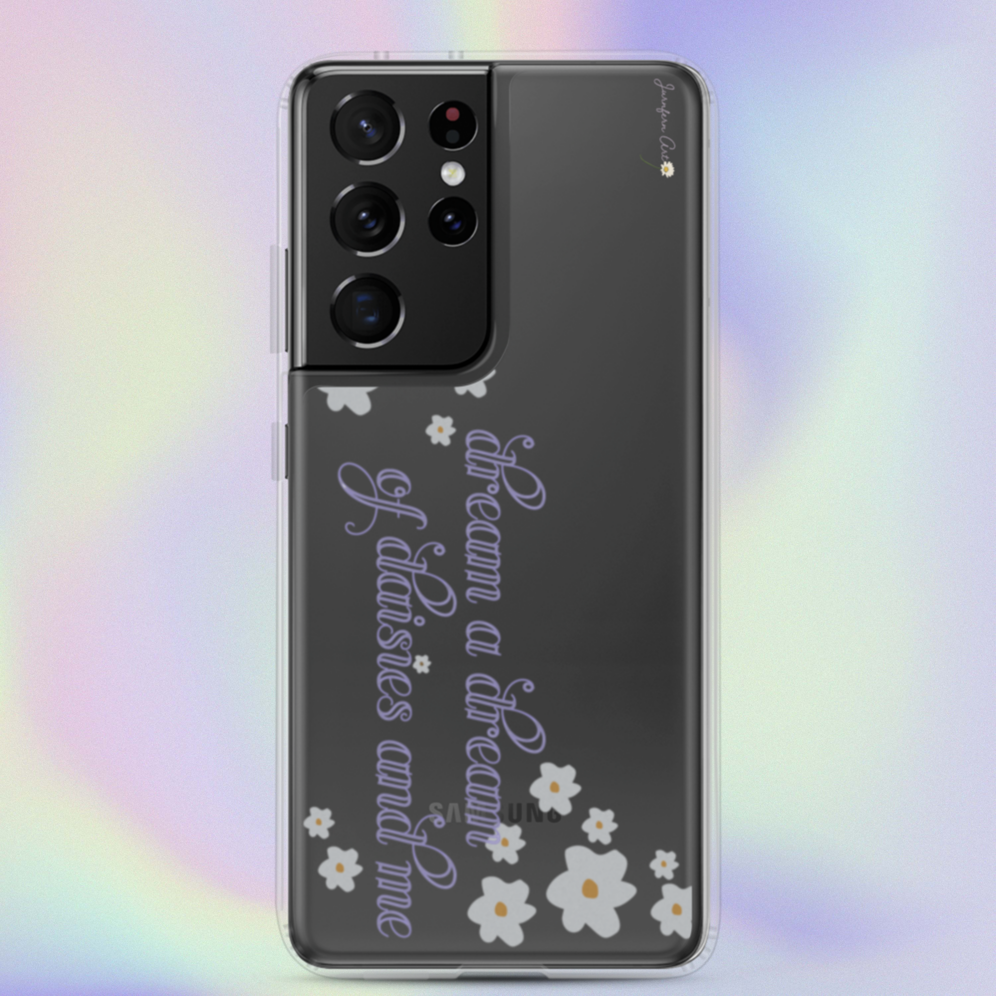 A transparent Samsung Galaxy S21 Ultra phone case with cursive lavender text on it that reads "dream a dream of daisies and me" surrounded by small daisies