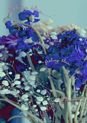 A close-up image of a bouquet of blue and purple flowers, and baby's breath