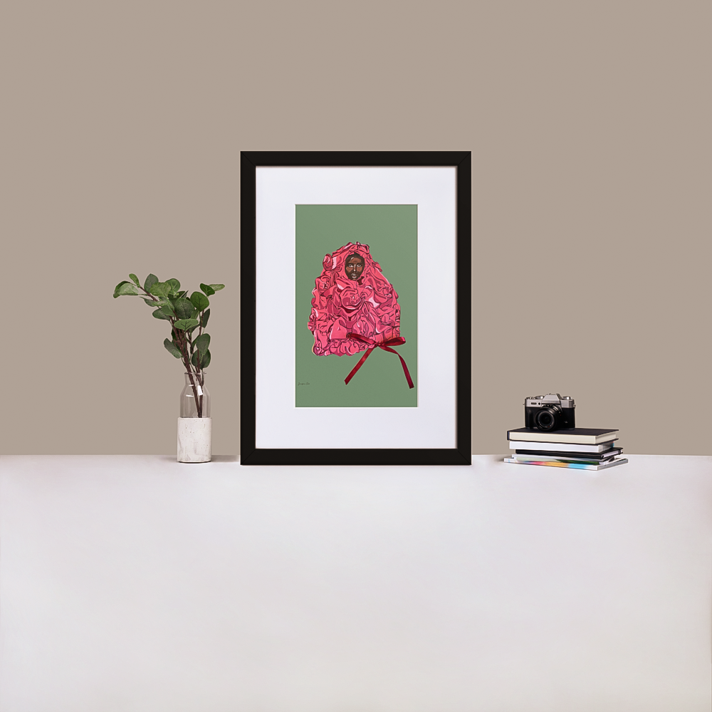 A black framed print with white board matting, with an illustration of Black supermodel Adut Akech wearing a pink Valentino gown with a bow on it, with a mint green background, standing up on a table next to a green plant and a stack of books