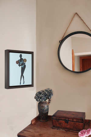 Framed wall art canvas in Light Blue by Jurnfern Art, of model Adut Akech, hanging on bedroom wall