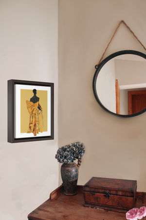 A framed canvas featuring a fashion illustration of Black model Akiima Ajak wearing a yellow Valentino gown with a large bow on the back, and a yellow background, hanging on a wall above a wood desk with a vase of flowers