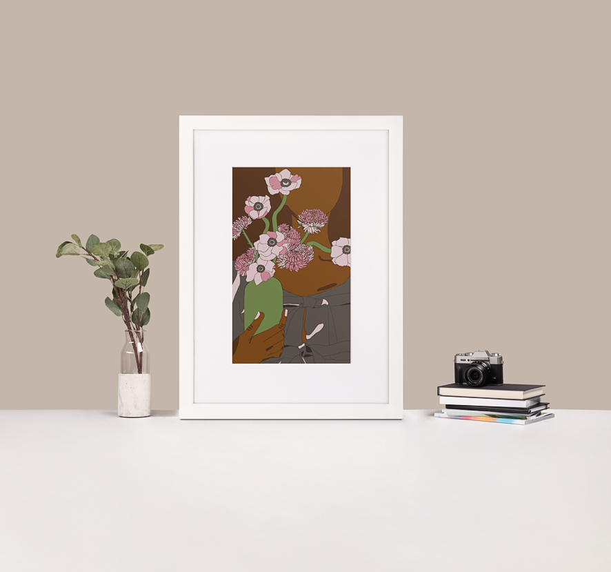 A minimalist graphic illustration of a Black woman holding a vase of flowers, framed in a black frame with a white mat boarder that is standing up on a white desk next to a plant and a stack of books