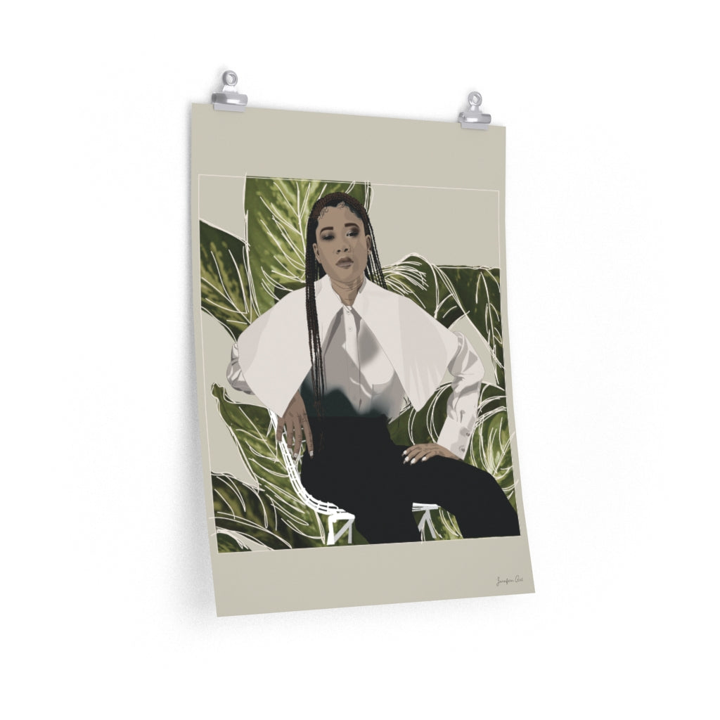 A 18 by 24 inch poster with a beige background and a digital illustration of Storm Reid posing in chair and wearing a white blouse with black trousers, with a cut-out photo of leaves behind her