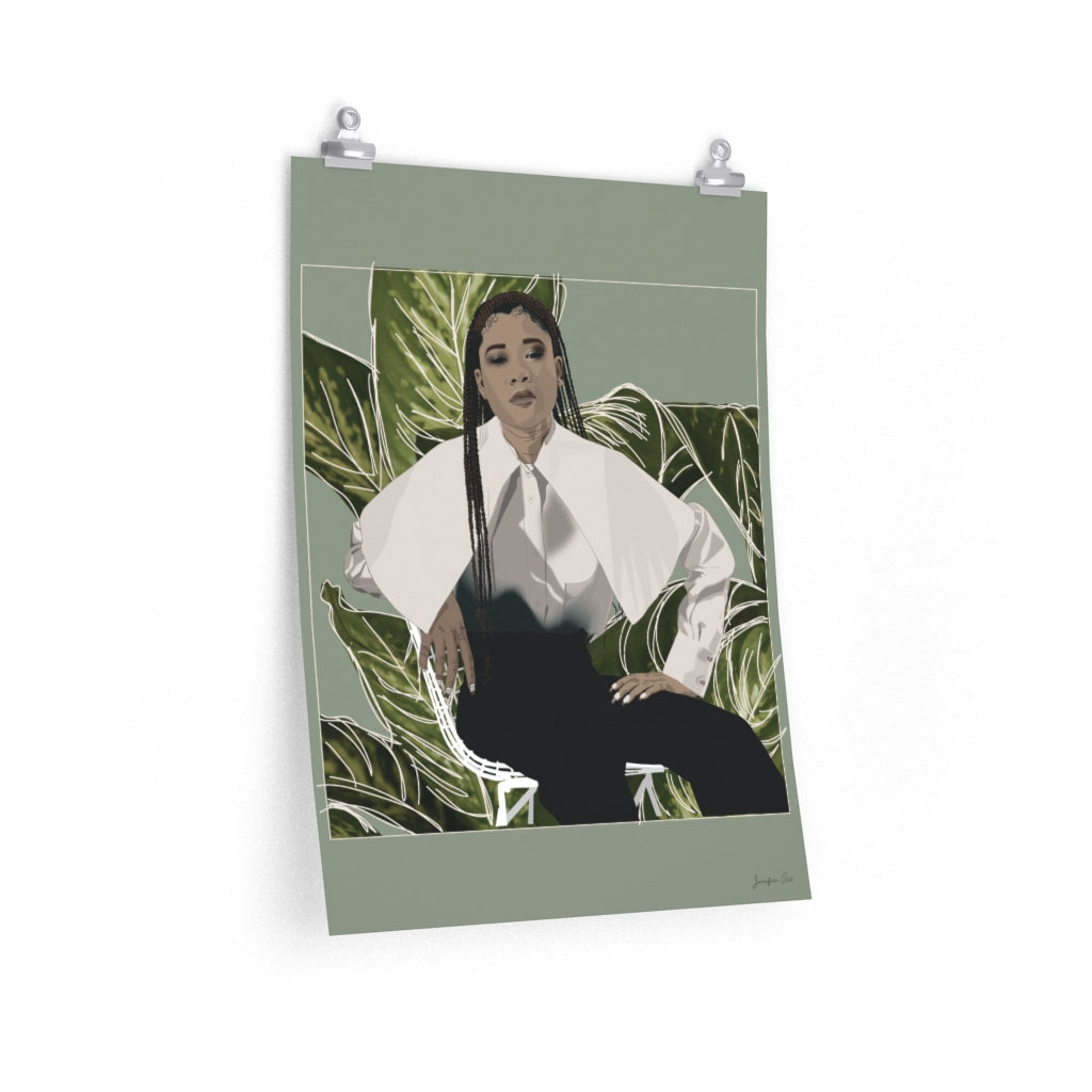A 18 by 24 inch poster with a green background and a digital illustration of Storm Reid posing in chair and wearing a white blouse with black trousers, with a cut-out photo of leaves behind her