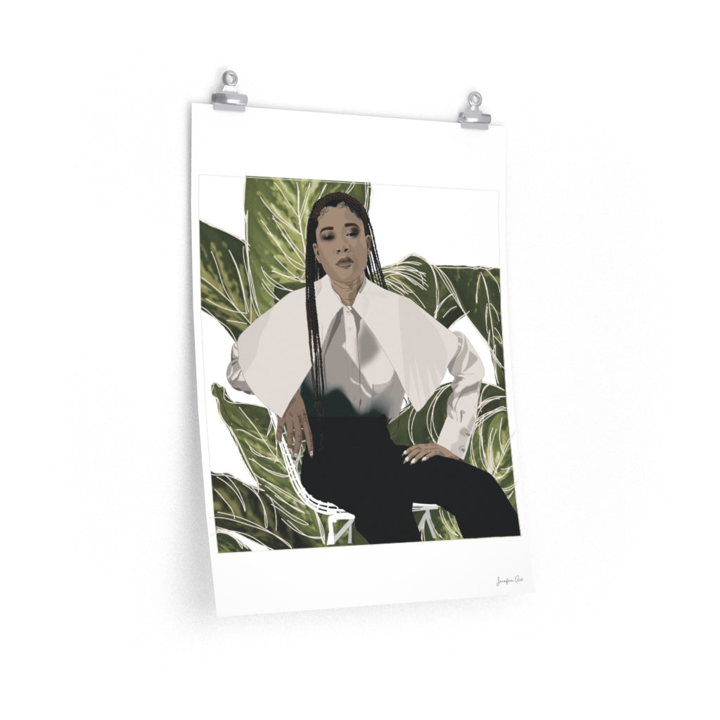 A 18 by 24 inch poster with a white background and a digital illustration of Storm Reid posing in chair and wearing a white blouse with black trousers, with a cut-out photo of leaves behind her