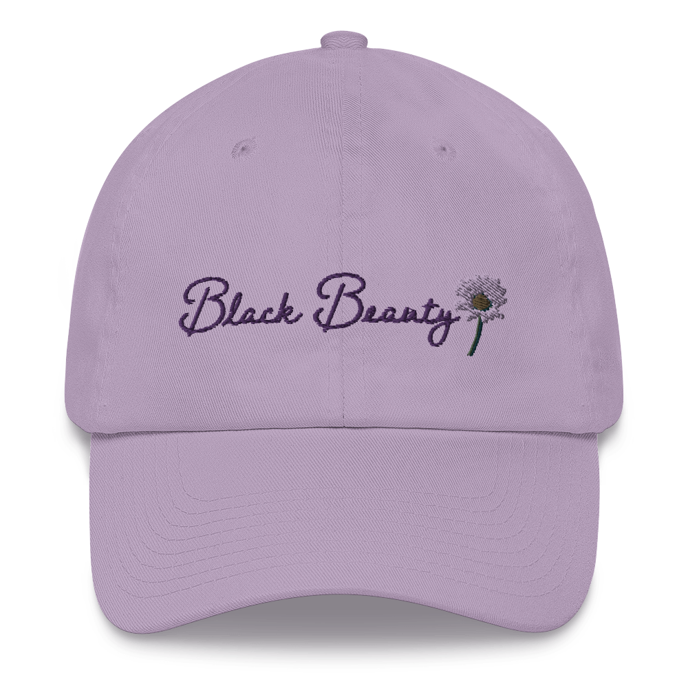 A lavender baseball cap with purple cursive embroidered text on it that reads "Black Beauty" with an embroidered daisy